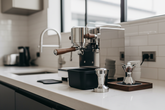 Professional espresso accessories including tamper and distribution tools on counter